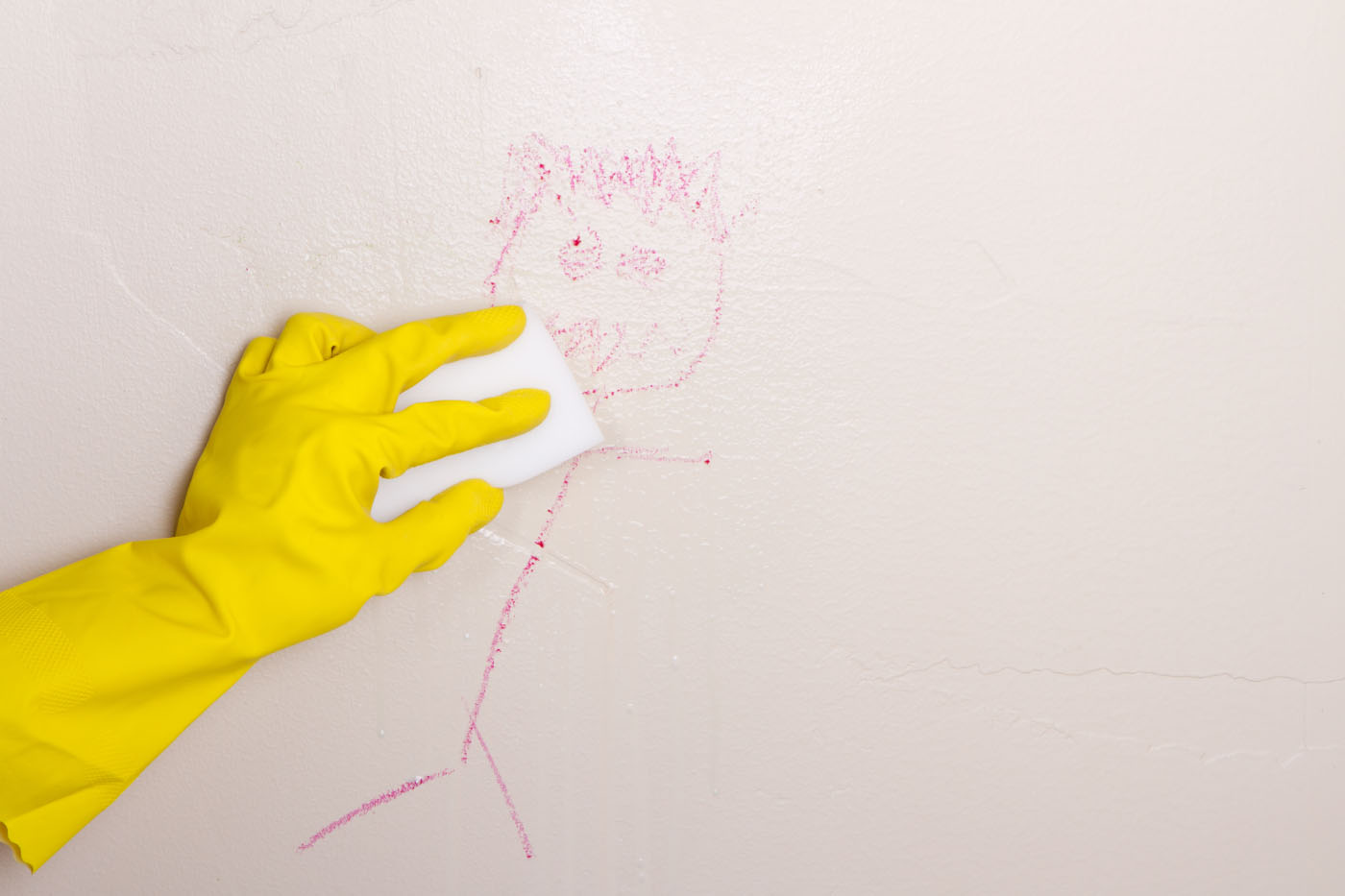 Using magic eraser to remove crayon from wall